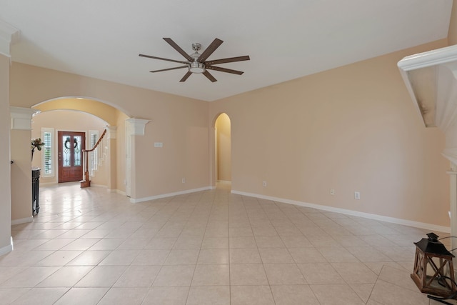31335 Bearing Star Ln, Tomball, TX 77375 - spare room featuring ceiling fan, arched walkways, ornate columns, and light tile patterned floors