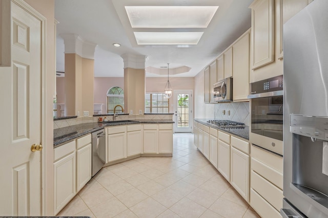 31335 Bearing Star Ln, Tomball, TX 77375 - kitchen featuring cream cabinets, stainless steel appliances, tasteful backsplash, light tile patterned floors, and recessed lighting