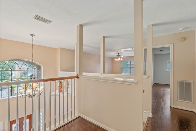 31335 Bearing Star Ln, Tomball, TX 77375 - hall featuring a chandelier, dark wood-type flooring, and an upstairs landing
