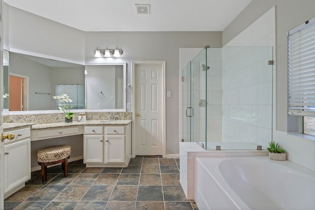 31335 Bearing Star Ln, Tomball, TX 77375 - full bath featuring vanity, a garden tub, a stall shower, and stone finish floors