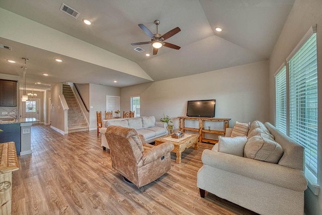 22168 Juniper Crossing Dr, New Caney, TX 77357 - living area featuring ceiling fan, stairway, light wood finished floors, vaulted ceiling, and baseboards