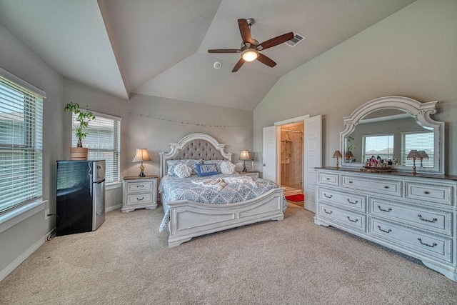 22168 Juniper Crossing Dr, New Caney, TX 77357 - bedroom with multiple windows, vaulted ceiling, carpet flooring, a ceiling fan, and ensuite bathroom