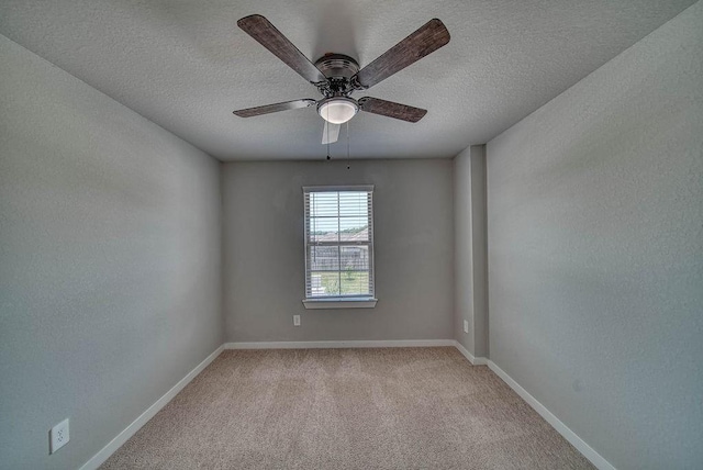 22168 Juniper Crossing Dr, New Caney, TX 77357 - unfurnished room featuring light colored carpet, baseboards, ceiling fan, and a textured ceiling