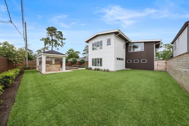 1518 Bayram Dr, Houston, TX 77055 - back of property with a fenced backyard, a patio area, and a gazebo