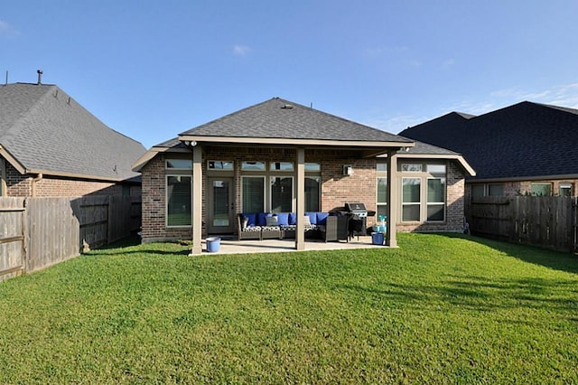 22419 Slate Oaks Ln, Richmond, TX 77469 - rear view of house with an outdoor hangout area, brick siding, a patio area, and roof with shingles