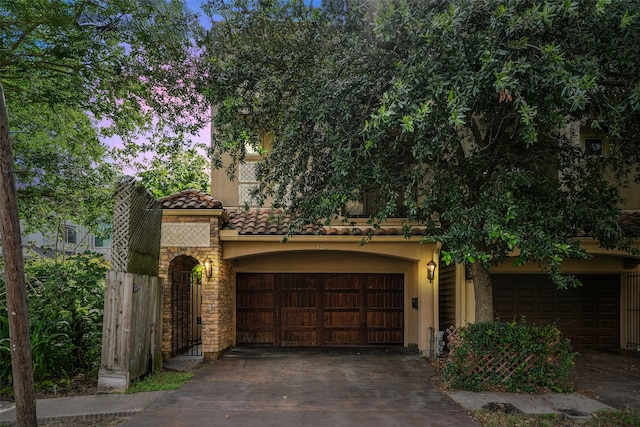 1215 Malone St, Houston, TX 77007 - view of front of home with driveway, stucco siding, a tiled roof, and stone siding