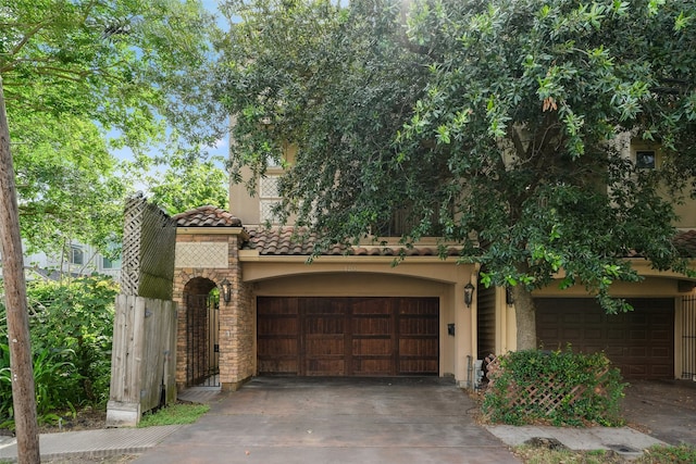 1215 Malone St, Houston, TX 77007 - view of front facade with stucco siding, concrete driveway, a garage, a tiled roof, and stone siding