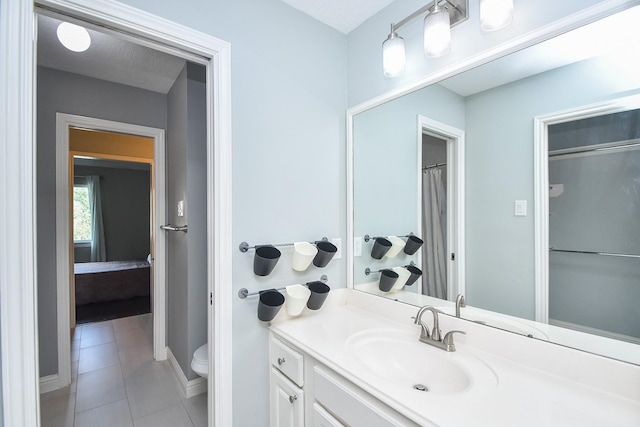 7103 Adobe Meadows Ct, Sugar Land, TX 77479 - ensuite bathroom featuring vanity, tile patterned floors, toilet, and baseboards