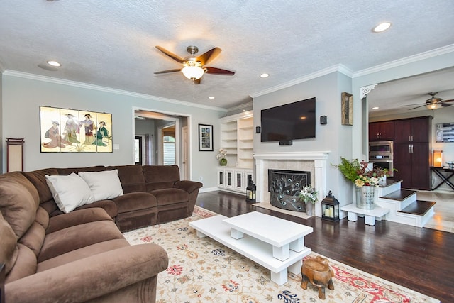 7103 Adobe Meadows Ct, Sugar Land, TX 77479 - living area featuring ceiling fan, wood finished floors, recessed lighting, a glass covered fireplace, and a textured ceiling