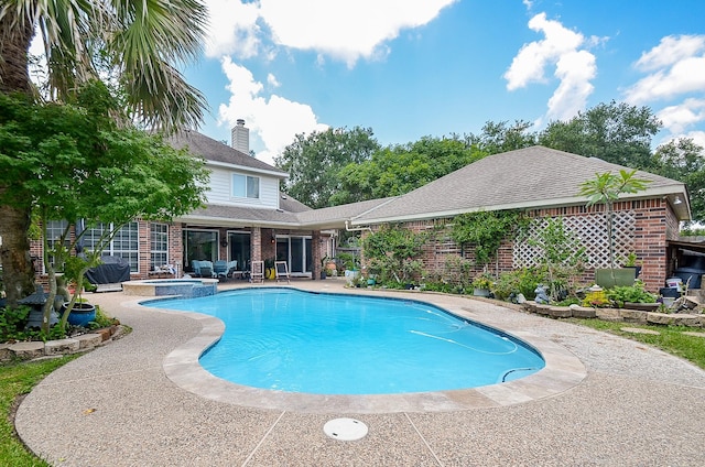 7103 Adobe Meadows Ct, Sugar Land, TX 77479 - view of swimming pool with a patio area and a pool with connected hot tub