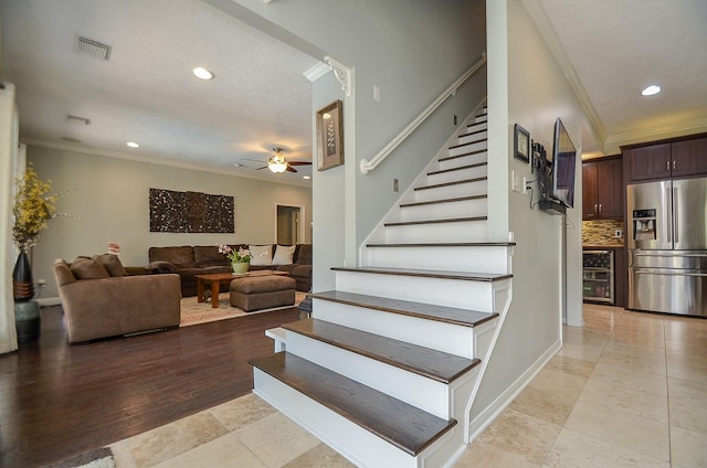 7103 Adobe Meadows Ct, Sugar Land, TX 77479 - stairway featuring ornamental molding, recessed lighting, a ceiling fan, wine cooler, and tile patterned flooring