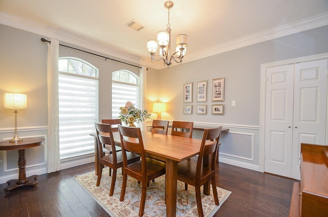 7103 Adobe Meadows Ct, Sugar Land, TX 77479 - dining space with a chandelier, ornamental molding, dark wood-style floors, wainscoting, and a decorative wall