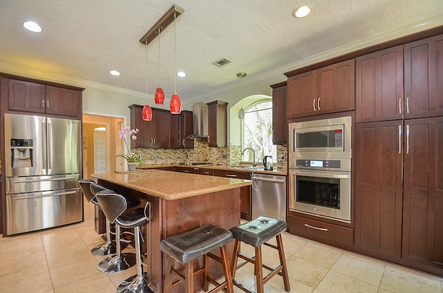 7103 Adobe Meadows Ct, Sugar Land, TX 77479 - kitchen with stainless steel appliances, crown molding, light tile patterned floors, tasteful backsplash, and a center island