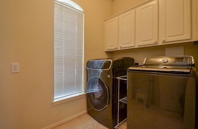 7103 Adobe Meadows Ct, Sugar Land, TX 77479 - washroom with cabinet space, separate washer and dryer, baseboards, and light tile patterned flooring
