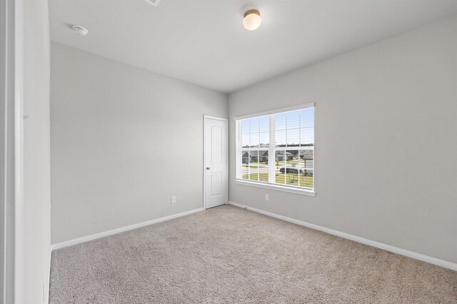 14008 Paddlefish Dr, Conroe, TX 77384 - spare room with carpet and a smoke detector