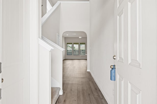 14008 Paddlefish Dr, Conroe, TX 77384 - hallway with stairs, wood finished floors, and arched walkways