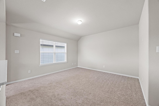 14008 Paddlefish Dr, Conroe, TX 77384 - carpeted empty room featuring baseboards and lofted ceiling