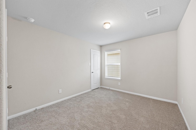 14008 Paddlefish Dr, Conroe, TX 77384 - carpeted spare room with a smoke detector and a textured ceiling