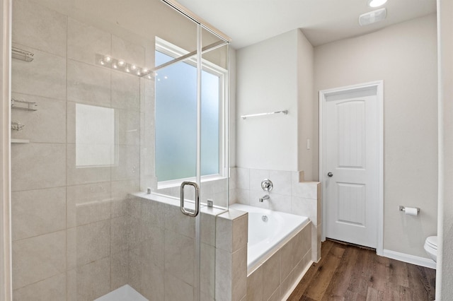14008 Paddlefish Dr, Conroe, TX 77384 - bathroom with a garden tub, a stall shower, and wood finished floors