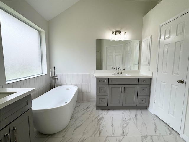 30611 Pinemill Hollow Dr, Spring, TX 77386 - bathroom featuring vanity, a soaking tub, marble finish floors, and wainscoting