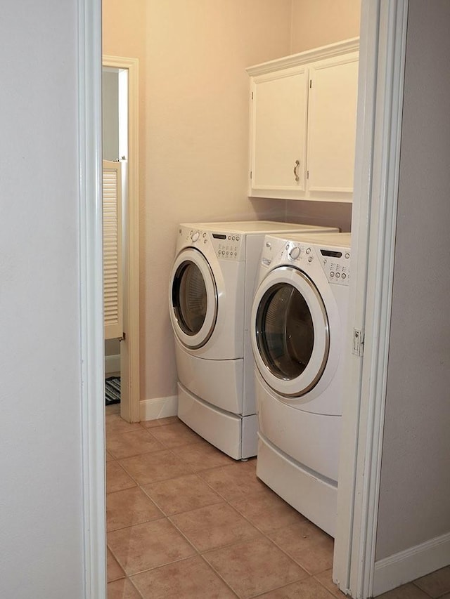 2862 Dees Cir, Sealy, TX 77474 - washroom featuring washer and dryer, cabinet space, light tile patterned floors, and baseboards