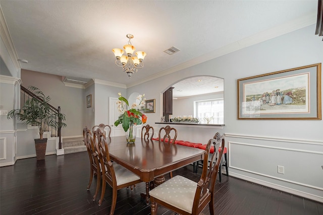 3426 Skyline Village Dr, Houston, TX 77057 - dining area with hardwood / wood-style floors, a chandelier, ornamental molding, and arched walkways