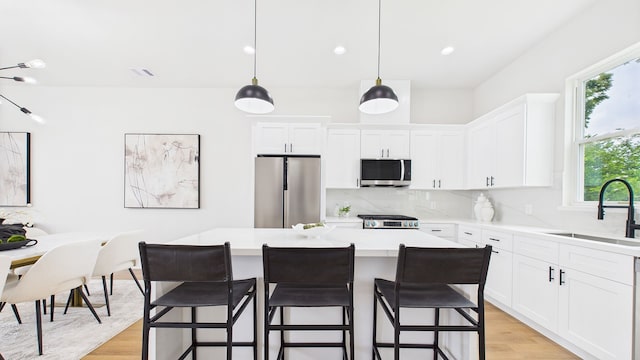 1813 Brooks St, Houston, TX 77026 - kitchen with appliances with stainless steel finishes, a sink, backsplash, light wood-style flooring, and recessed lighting