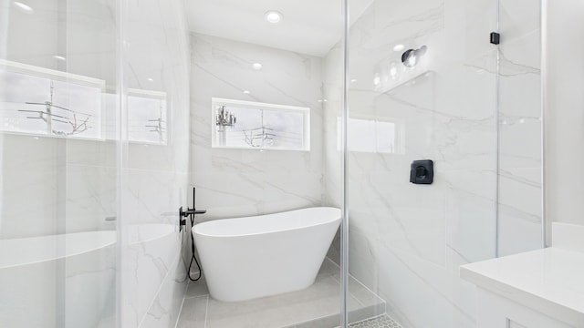 1813 Brooks St, Houston, TX 77026 - bathroom featuring a marble finish shower, a soaking tub, tile walls, and healthy amount of natural light