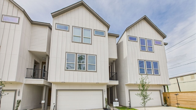 1813 Brooks St, Houston, TX 77026 - view of property with a balcony, an attached garage, driveway, and board and batten siding