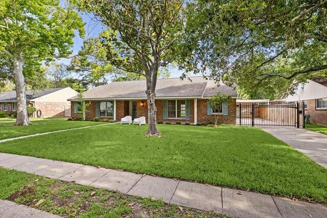 10715 Piping Rock Ln, Houston, TX 77042 - ranch-style house with a gate, concrete driveway, brick siding, a carport, and a front lawn
