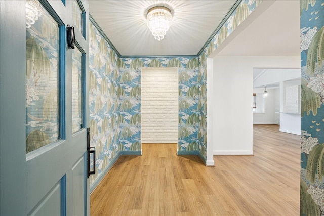 10715 Piping Rock Ln, Houston, TX 77042 - foyer entrance featuring baseboards, wallpapered walls, wood finished floors, and a chandelier