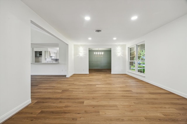 10715 Piping Rock Ln, Houston, TX 77042 - unfurnished room featuring a chandelier, light wood-style floors, recessed lighting, and baseboards
