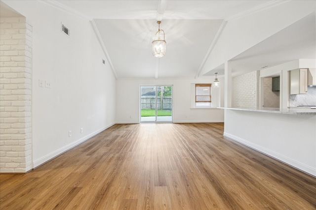 10715 Piping Rock Ln, Houston, TX 77042 - unfurnished living room with vaulted ceiling, crown molding, light wood finished floors, baseboards, and a chandelier
