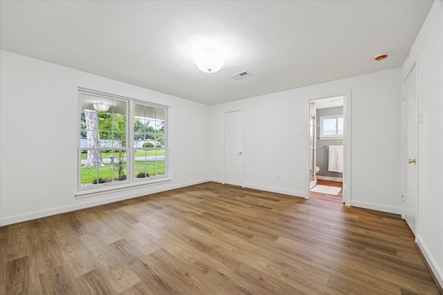 10715 Piping Rock Ln, Houston, TX 77042 - unfurnished bedroom featuring light wood-style floors, baseboards, and ensuite bathroom