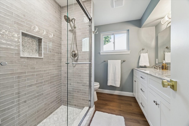 10715 Piping Rock Ln, Houston, TX 77042 - full bathroom with tiled shower, vanity, toilet, wood finished floors, and baseboards