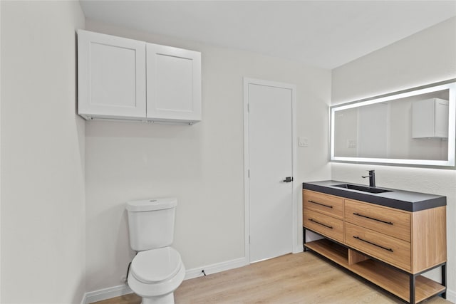 3805 19th St N, Texas City, TX 77590 - bathroom featuring wood finished floors, vanity, toilet, and baseboards