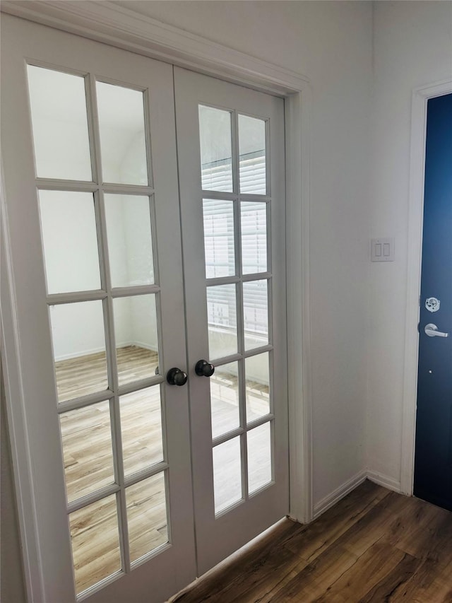 3713 NE River Sand Rd, Rosenberg, TX 77469 - doorway to outside with french doors, dark wood-style floors, and baseboards
