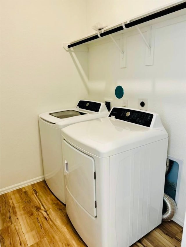 3713 NE River Sand Rd, Rosenberg, TX 77469 - laundry area featuring washer and dryer, light wood-style flooring, and baseboards