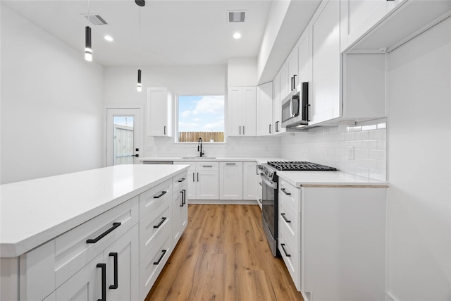 7719 Orebo St, Houston, TX 77088 - kitchen with stainless steel appliances, a sink, tasteful backsplash, light countertops, and recessed lighting