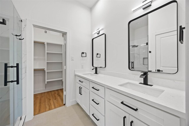 7719 Orebo St, Houston, TX 77088 - full bath with a marble finish shower, double vanity, tile patterned floors, and a spacious closet