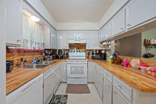 112 N Forest Dr, Willis, TX 77378 - kitchen featuring white appliances, a sink, under cabinet range hood, wood counters, and a peninsula