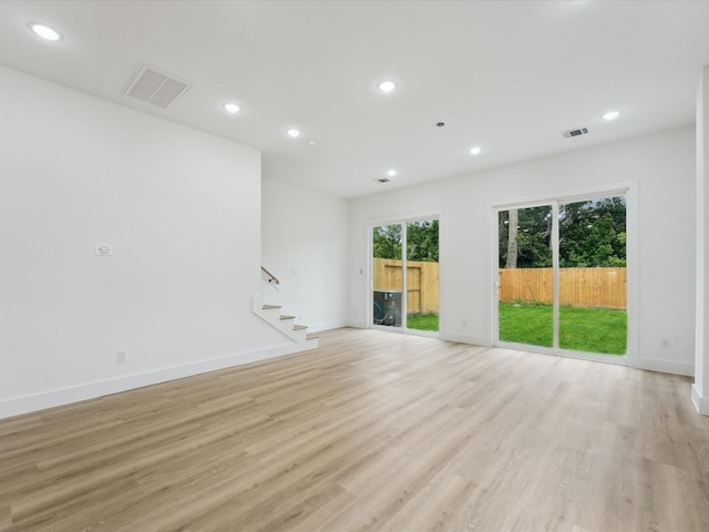 7416 Maxroy St, Houston, TX 77088 - unfurnished living room with stairs, light wood-style flooring, recessed lighting, and baseboards