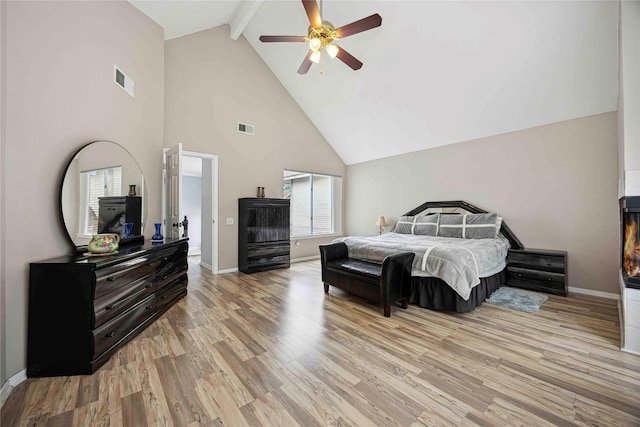 16019 Juniper Grove Dr, Houston, TX 77084 - bedroom with beamed ceiling, wood finished floors, high vaulted ceiling, baseboards, and a ceiling fan