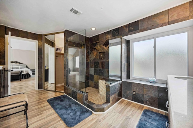 16019 Juniper Grove Dr, Houston, TX 77084 - bathroom featuring a tile shower, wood finished floors, ensuite bathroom, and vanity
