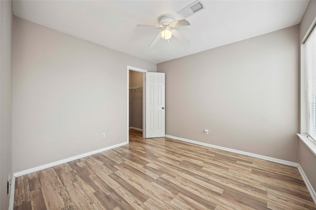 16019 Juniper Grove Dr, Houston, TX 77084 - unfurnished bedroom featuring light wood-style flooring, baseboards, a closet, and multiple windows