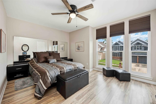 16019 Juniper Grove Dr, Houston, TX 77084 - bedroom with light wood-type flooring, baseboards, and ceiling fan