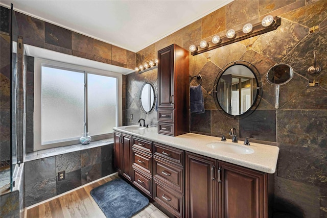 16019 Juniper Grove Dr, Houston, TX 77084 - full bath featuring tile walls, double vanity, and wood finished floors