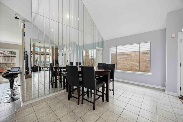 16019 Juniper Grove Dr, Houston, TX 77084 - dining room with light tile patterned floors, plenty of natural light, baseboards, and vaulted ceiling