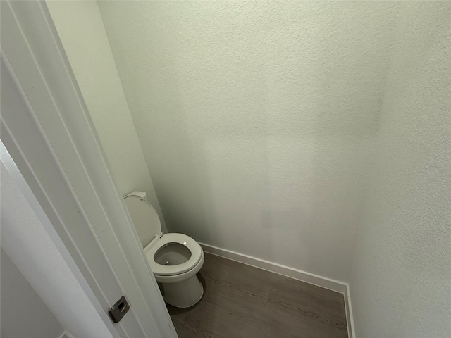 1303 Garrett Sudhendrio Dr, Crosby, TX 77532 - bathroom featuring wood finished floors, toilet, and baseboards
