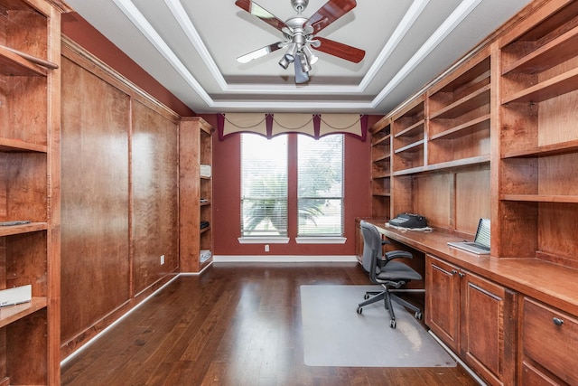 16206 Lobo Ln, Spring, TX 77379 - home office with a raised ceiling, built in study area, dark wood-type flooring, ceiling fan, and baseboards